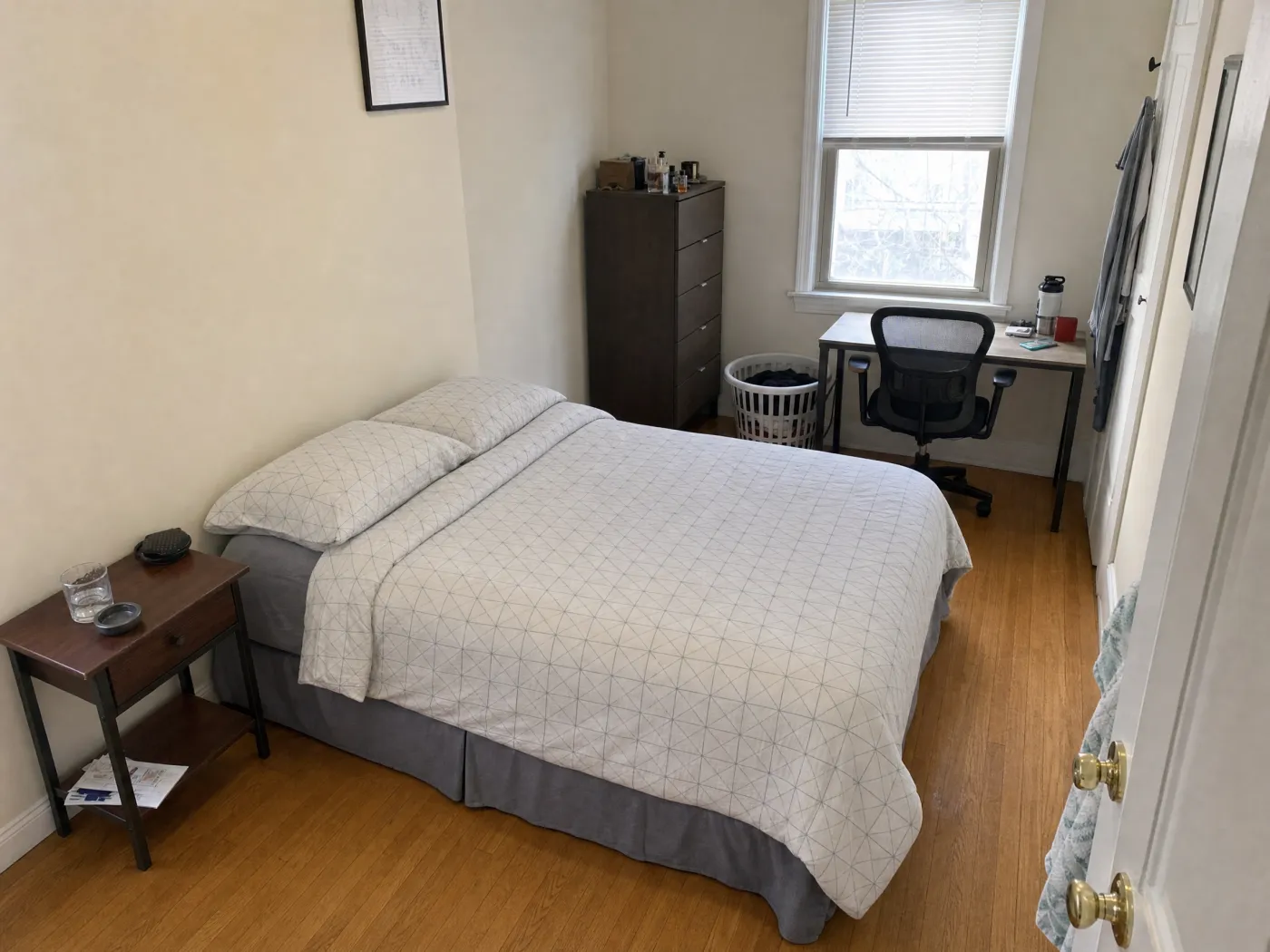 The same bedroom with the same furniture arranged into a calm, open layout