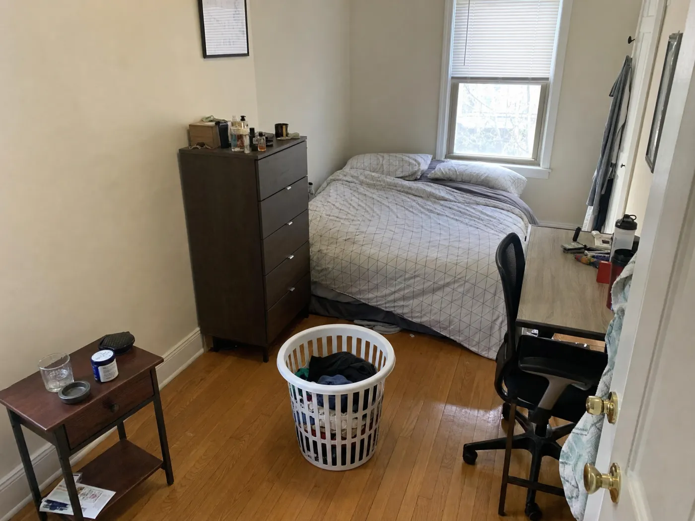 Cramped bedroom with the bed jammed in a corner before rearranging